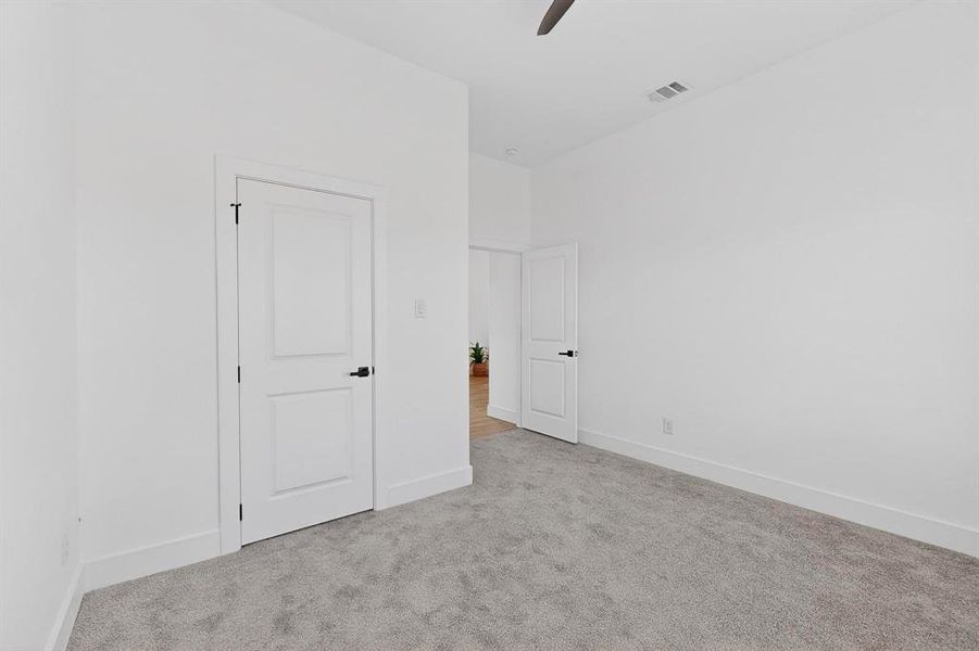 Unfurnished bedroom featuring carpet and ceiling fan