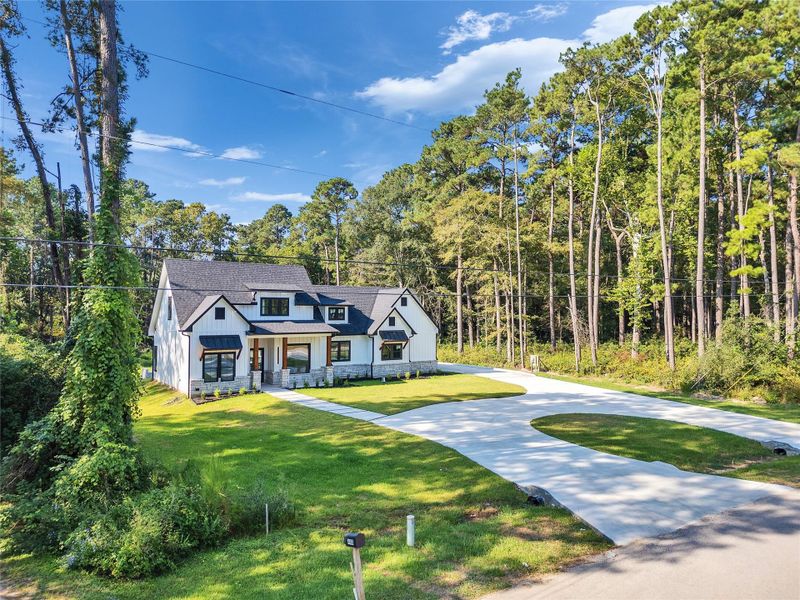 Front exterior of a new home in , Magnolia, TX, highlighting curb appeal (Image 31).