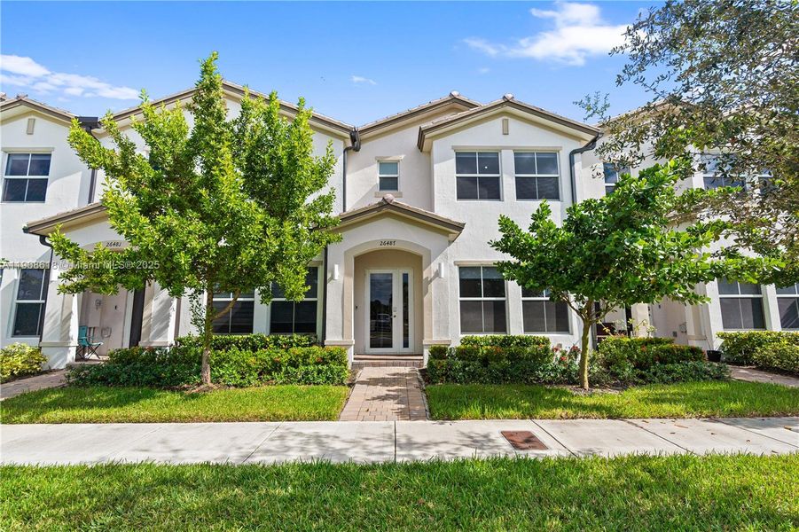 Front exterior of a new home in Harmony Parc, Homestead, FL, highlighting curb appeal (Image 22).