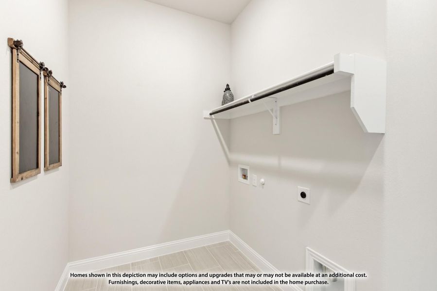 Laundry room with white wall-mounted shelf, hanging rod, washer and dryer hookups, and tile floor