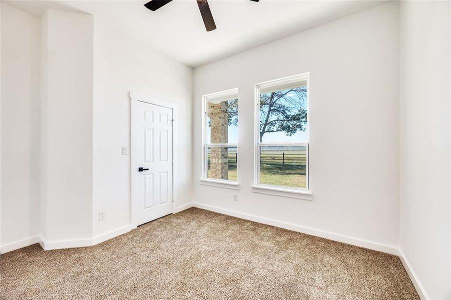Spare room featuring carpet floors and ceiling fan