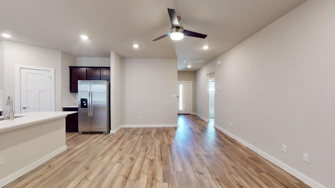 A contemporary open-concept layout unites the kitchen and living areas, highlighted by durable hardwood flooring. A contemporary open-concept layout unites the kitchen and living areas, highlighted by durable hardwood flooring.