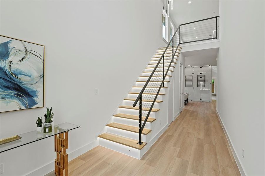 Stairs featuring wood finished floors