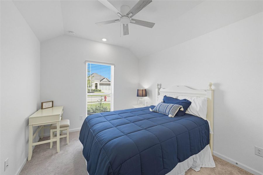 This secondary bedroom is cozy and bright, featuring a vaulted ceiling and a window for lots of natural light, as well as a ceiling fan. This secondary bedroom is cozy and bright, featuring a vaulted ceiling and a window for lots of natural light, as well as a ceiling fan.