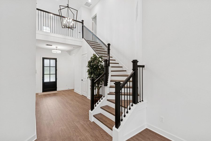 Grand entry with 2 story ceiling and stairway with wood treads and iron spindles to compliment this spacious Foyer!