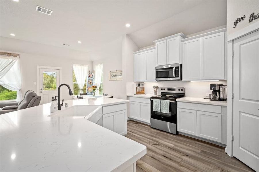 A closer view of your beautiful kitchen (note the farmhouse sink) and dining area.