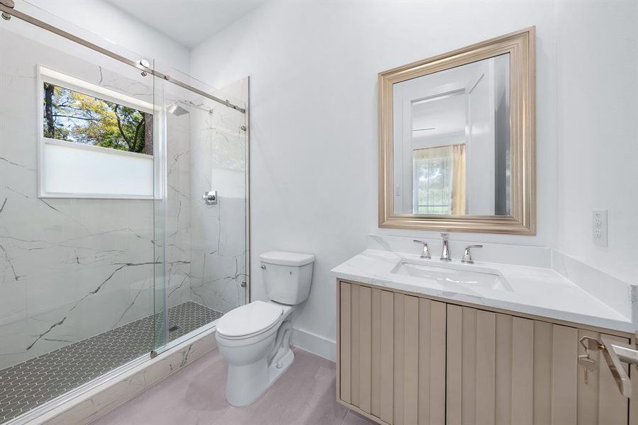 Full bathroom featuring a marble finish shower and vanity Full bathroom featuring a marble finish shower and vanity
