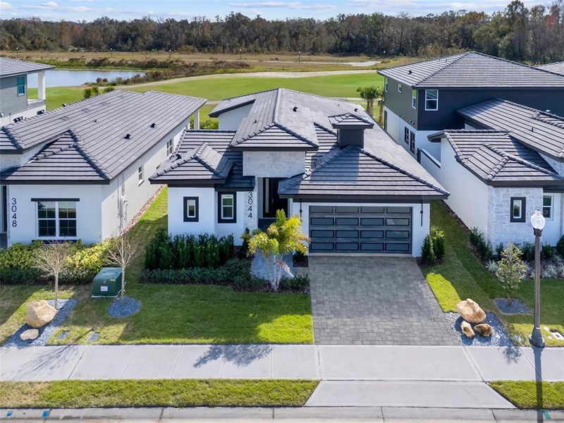 Front exterior of a new home in Hampton Green at Providence, Davenport, FL, highlighting curb appeal (Image 21).