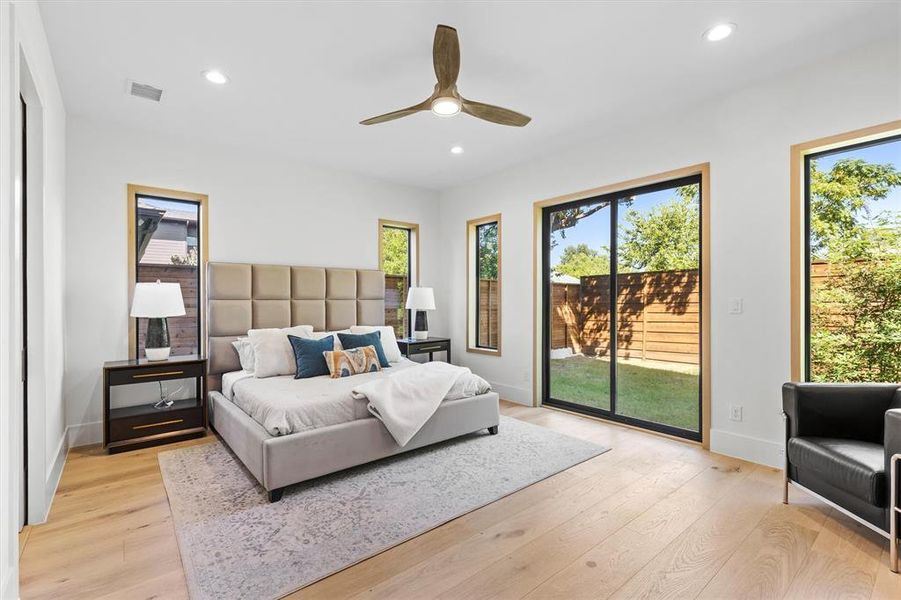 Bedroom featuring light wood-type flooring, ceiling fan, and access to exterior