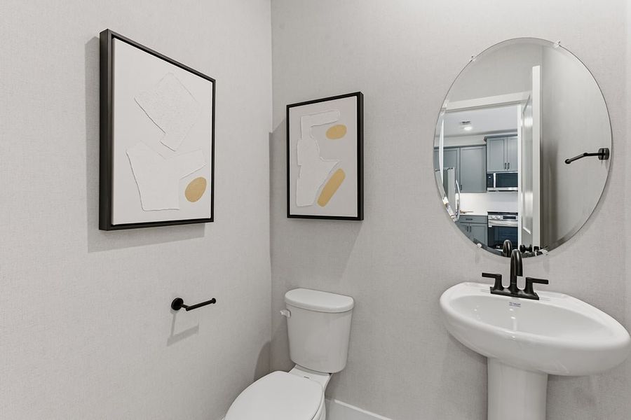 A bathroom with a toilet and a mirror.