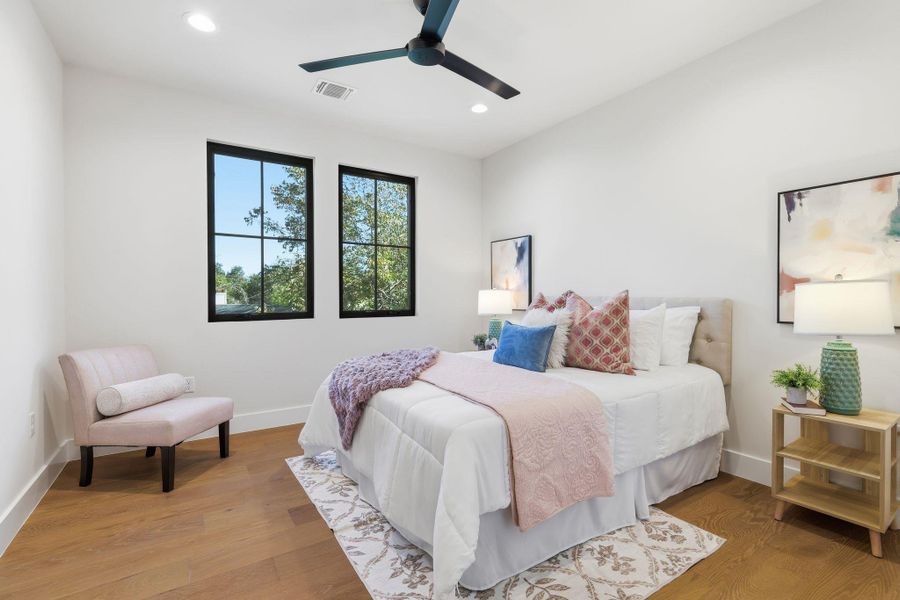 Bedroom with light wood-style flooring, a ceiling fan, and recessed lighting