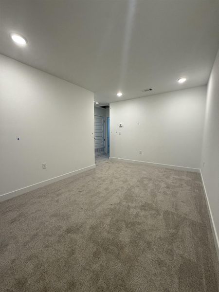 Carpeted spare room with baseboards and recessed lighting