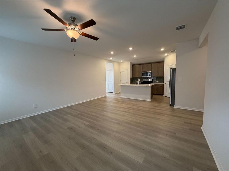 Unfurnished living room featuring recessed lighting, dark wood-style floors, and ceiling fan
