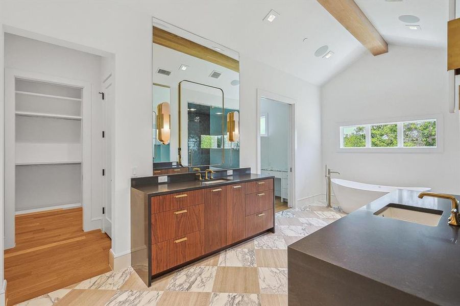 The primary bathroom offers back-lit light fixtures and dual walk in closets.