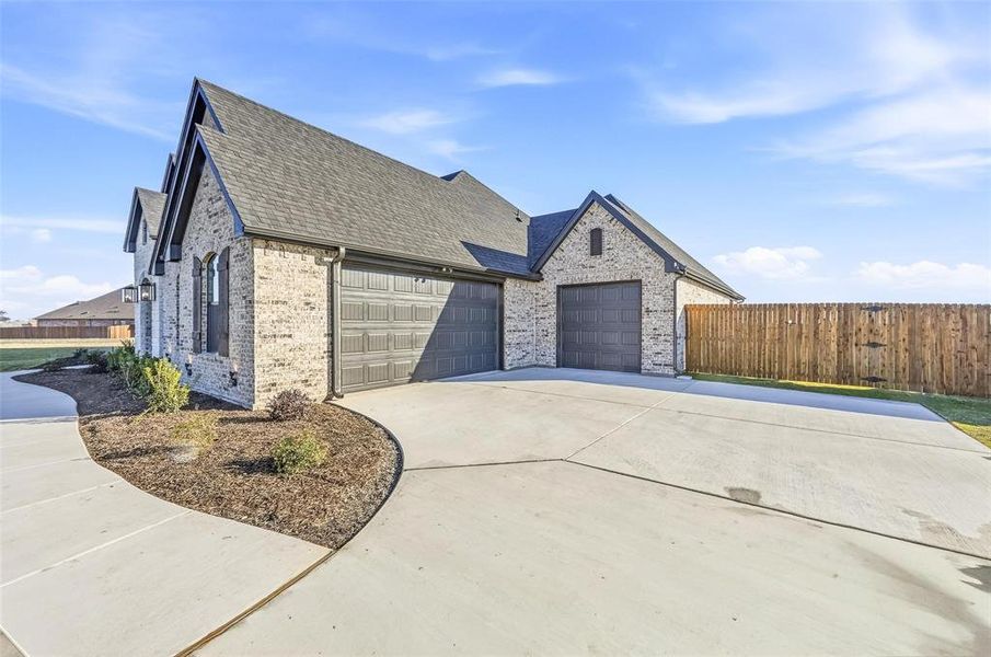 Front exterior of a new home in Coyote Crossing, Godley, TX, highlighting curb appeal (Image 2).