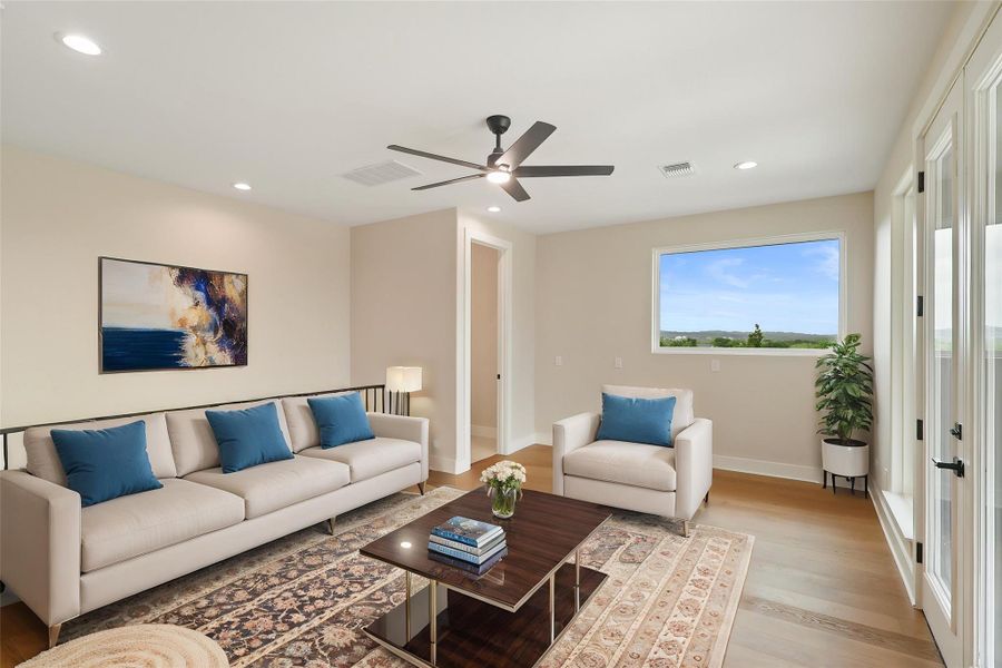 Living room with baseboards, visible vents, a ceiling fan, and light wood-type flooring Living room with baseboards, visible vents, a ceiling fan, and light wood-type flooring