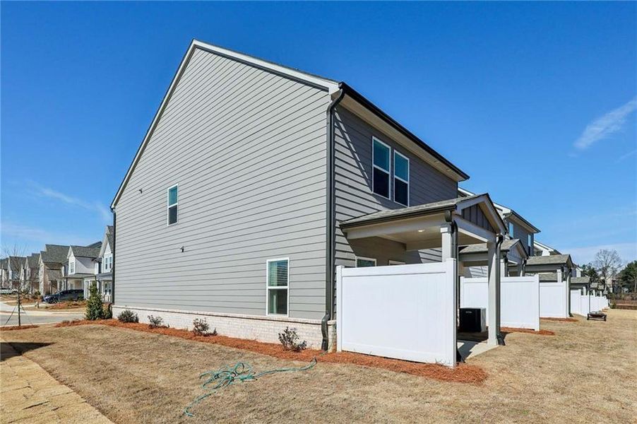 Exterior details and patio area of a home in Eastlyn Crossing, Flowery Branch (Image 4).