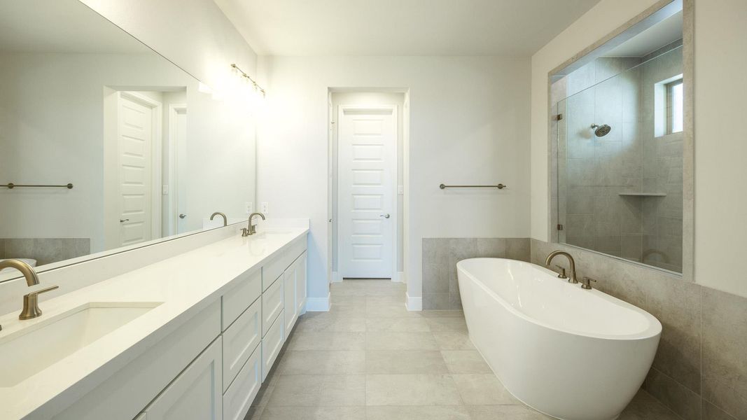 Bathroom with a freestanding bath, double vanity, and a tile shower Bathroom with a freestanding bath, double vanity, and a tile shower