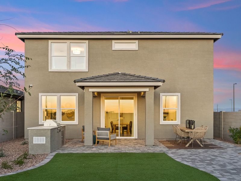 A house with a patio and a table and chairs in the front. A house with a patio and a table and chairs in the front.