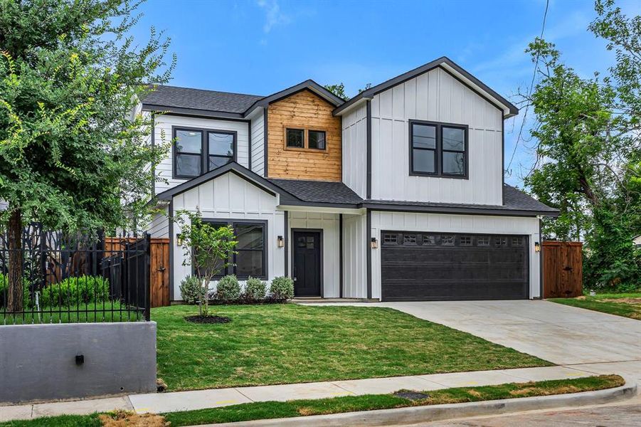 View of front facade with roof with shingles, board and batten siding, a garage, and driveway View of front facade with roof with shingles, board and batten siding, a garage, and driveway