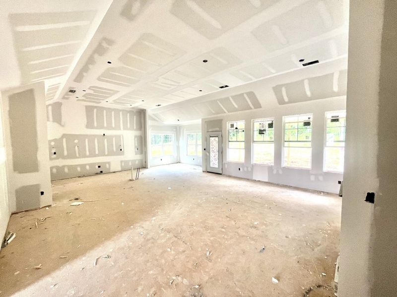 From the fireplace wall looking back at kitchen and dinning area. Kitchen will feature a large island