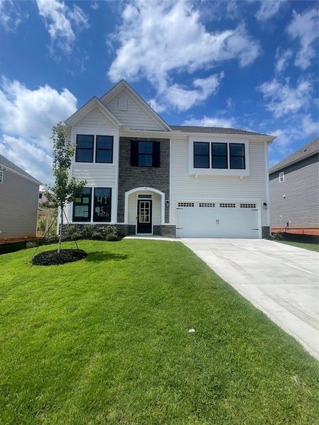 Front exterior of a new home in Springwood Grove, Central, SC, highlighting curb appeal (Image 1). Front exterior of a new home in Springwood Grove, Central, SC, highlighting curb appeal (Image 1).