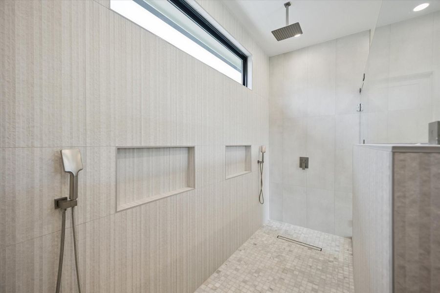 Spacious walk-in shower with dual rain shower heads, the perfect place to unwind and relax. Spacious walk-in shower with dual rain shower heads, the perfect place to unwind and relax.