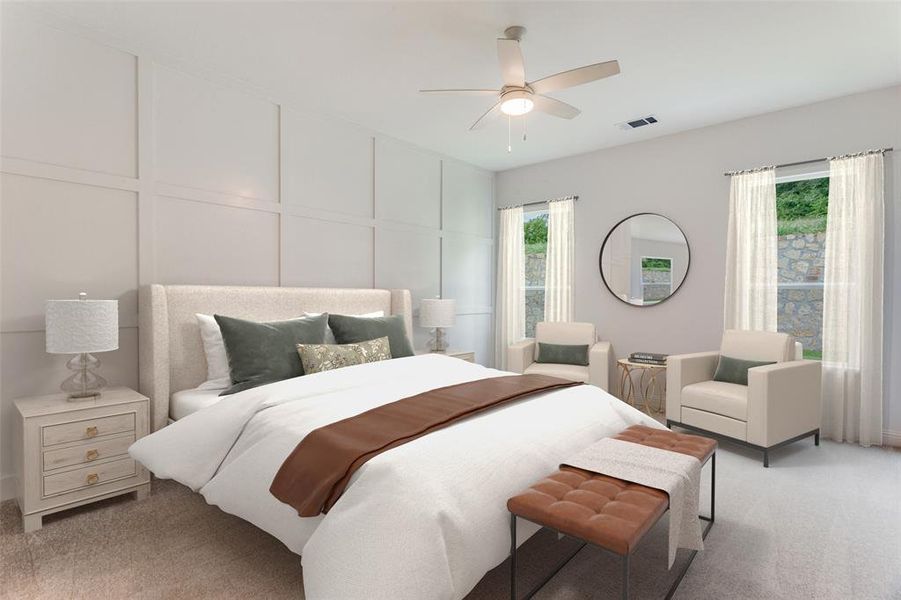 Bedroom with a decorative wall, light colored carpet, and ceiling fan