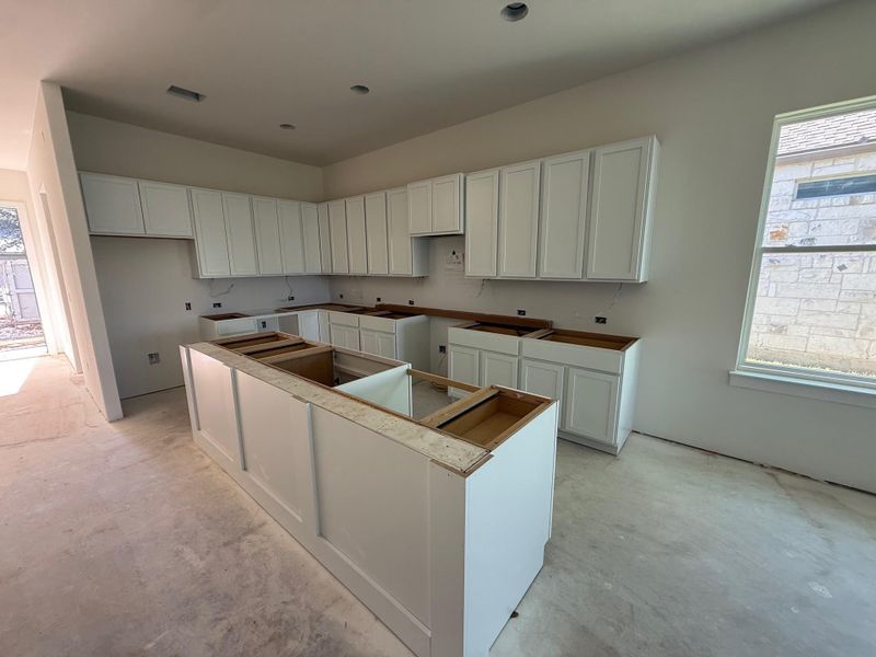 Kitchen with white cabinetry and a kitchen island