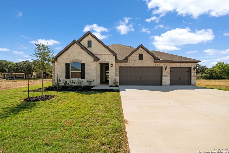 Front exterior of a new home in , Castroville, TX, highlighting curb appeal (Image 20).