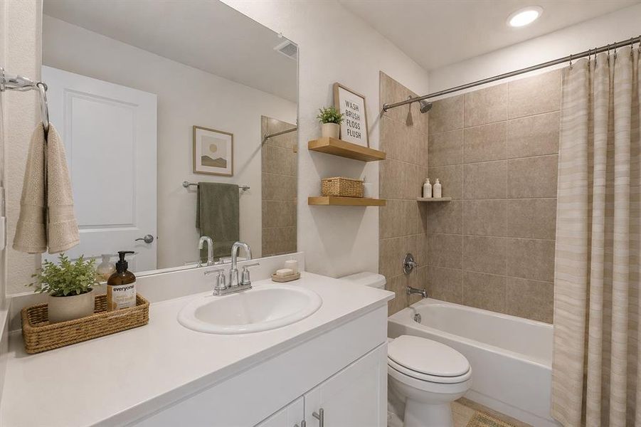 *Virtually Staged * Bathroom featuring a white vanity with an integrated sink, polished chrome faucet, and a large wall-mounted mirror