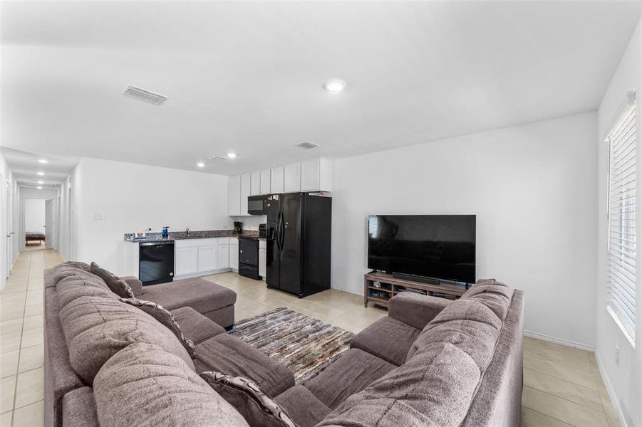 Living area featuring light tile patterned floors and recessed lighting Living area featuring light tile patterned floors and recessed lighting