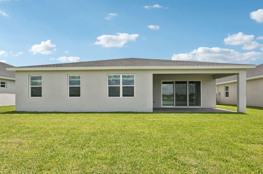 Front exterior of a new home in Hampton Park - Signature Series, Vero Beach, FL, highlighting curb appeal (Image 20). Front exterior of a new home in Hampton Park - Signature Series, Vero Beach, FL, highlighting curb appeal (Image 20).