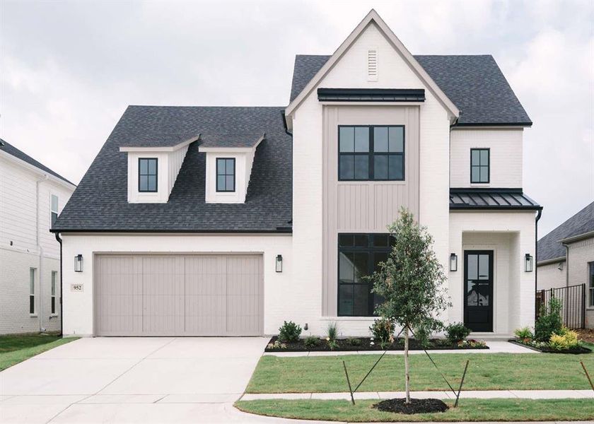 Modern farmhouse style home with a front lawn and a garage