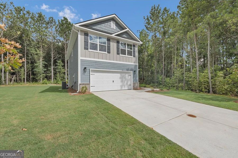 Front exterior of a new home in Canterbury Villas, Carrollton, GA, highlighting curb appeal (Image 2). Front exterior of a new home in Canterbury Villas, Carrollton, GA, highlighting curb appeal (Image 2).