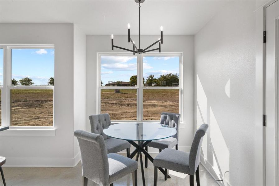 Dining room with a chandelier and a healthy amount of sunlight