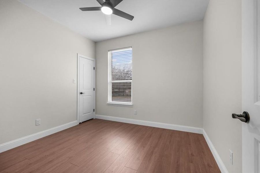 Unfurnished room featuring hardwood / wood-style flooring and ceiling fan