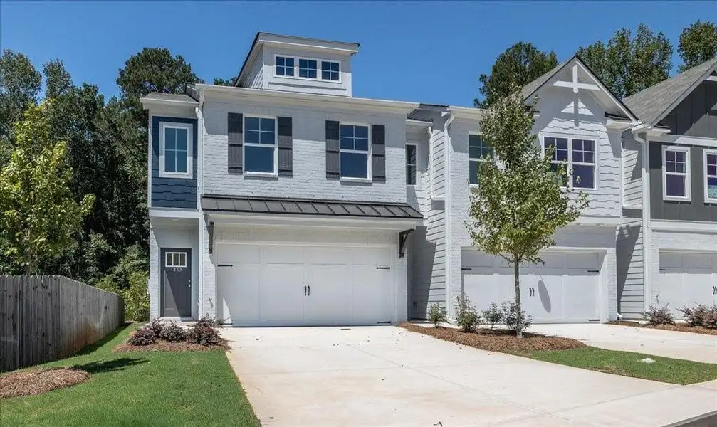 Front exterior of a new home in Shoals Crossing, Conyers, GA, highlighting curb appeal (Image 2). Front exterior of a new home in Shoals Crossing, Conyers, GA, highlighting curb appeal (Image 2).