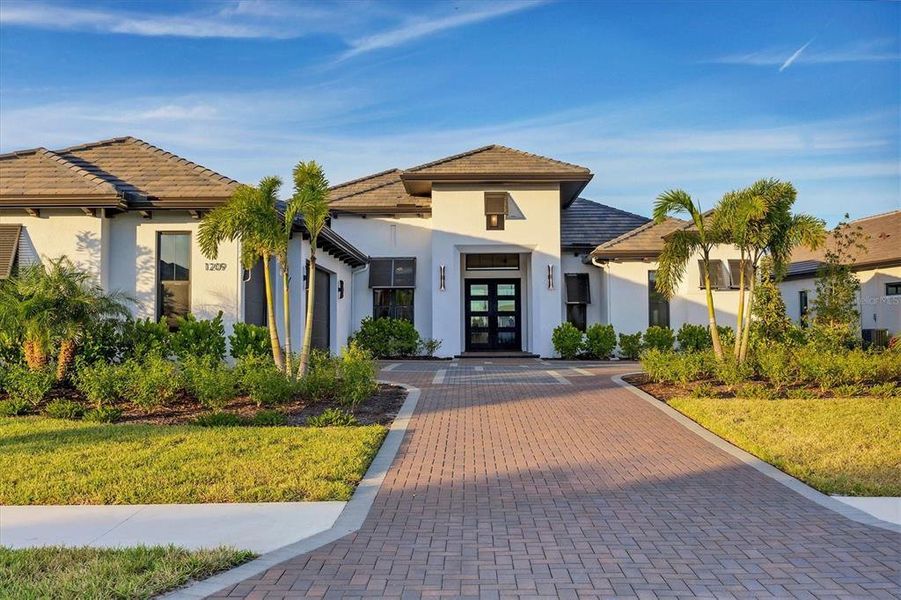 Front exterior of a new home in Wild Blue at Waterside, Sarasota, FL, highlighting curb appeal (Image 22).
