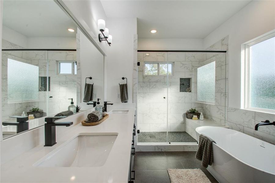 The primary bathroom has both a freestanding tub and a separate shower! Model home photos, finishes and floor plan MAY VARY!