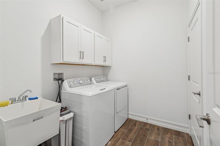 laundry room with additional cabinets and wash tub