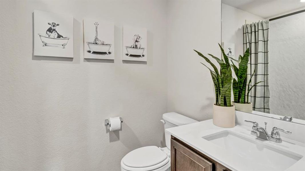 Bathroom vanity with a white countertop and integrated sink, chrome faucet, and dark wood-finish cabinetry Bathroom vanity with a white countertop and integrated sink, chrome faucet, and dark wood-finish cabinetry