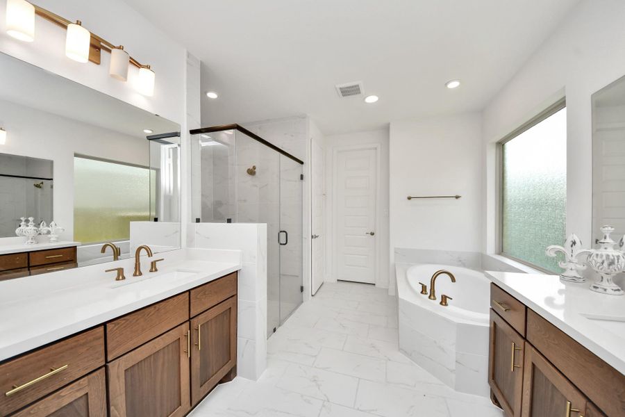Primary bathroom with functional layout and ample space.