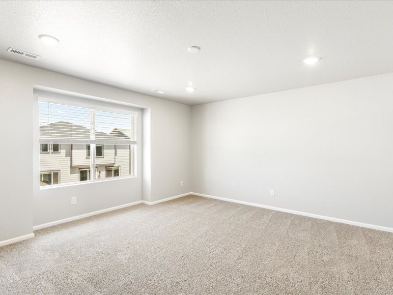 Primary bedroom in the Wateron floorplan at a Meritage Homes community in Brighton, CO.