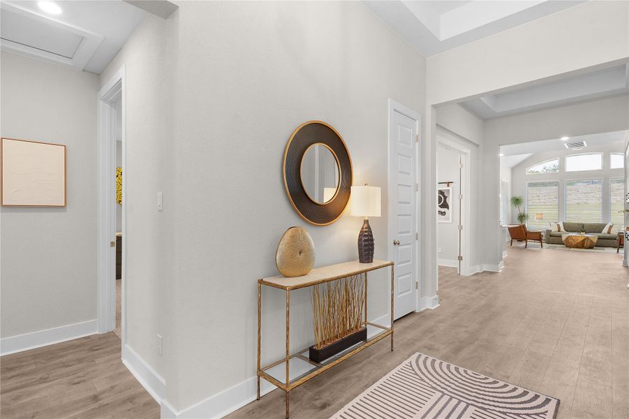 Step into this welcoming entryway, featuring wood flooring and a graceful transition into the living area beyond.