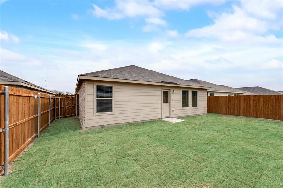 Rear view of house with a yard