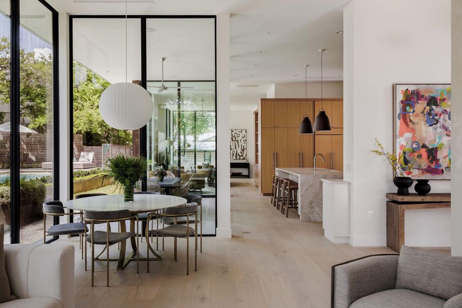 Dining area with floor to ceiling windows and light wood-type flooring Dining area with floor to ceiling windows and light wood-type flooring