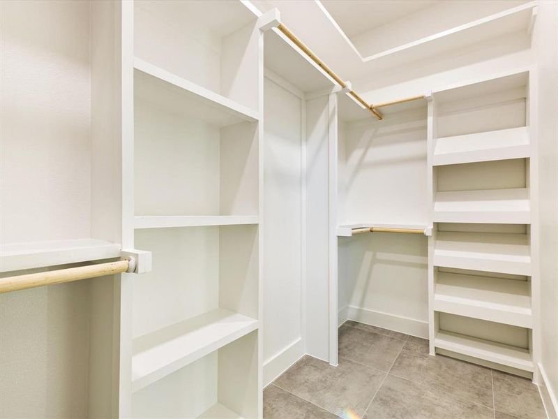 Spacious closet with light tile patterned floors