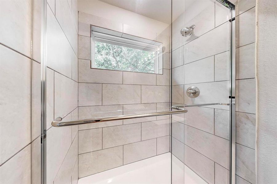 Bathroom featuring a shower with shower door