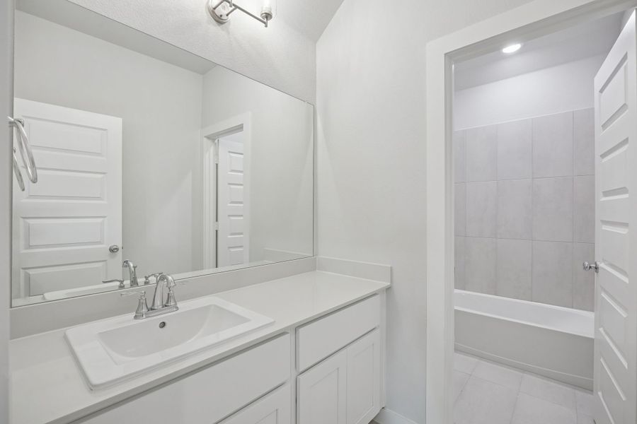 Bathroom in the Masters home plan by Trophy Signature Homes – REPRESENTATIVE PHOTO